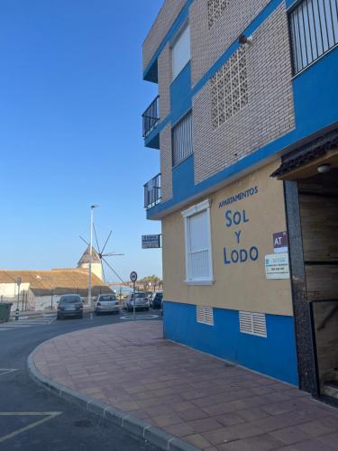 a building with a sign on the side of it at Apartamentos Sol y Lodo in Lo Pagán