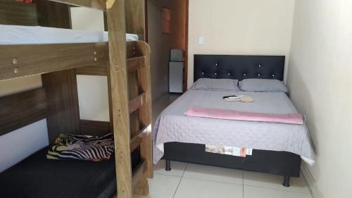 a bedroom with a bed and two bunk beds at Dom Antonio 3 in Campos dos Goytacazes