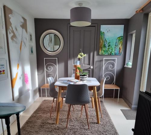 a dining room with a table and chairs at An Artist's Cottage in Fishguard