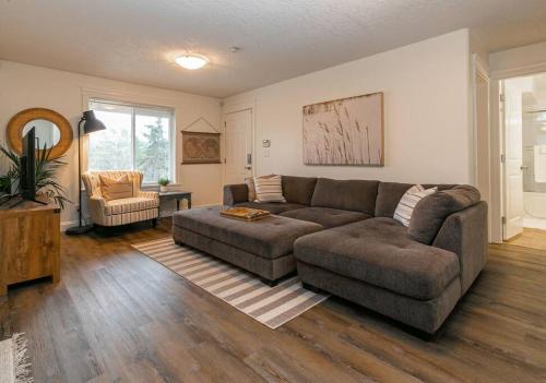 a living room with a couch and a chair at Cozy Renovated Oasis W Private Terrace & Parking in Victoria