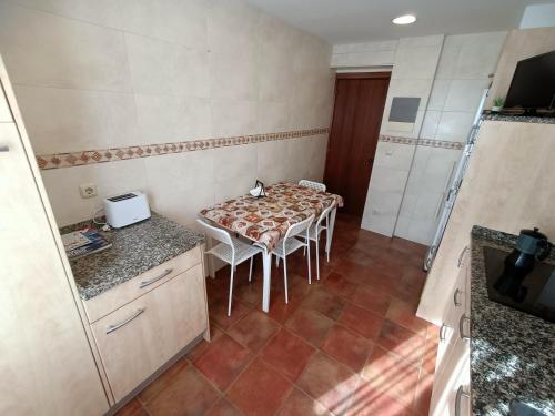 a kitchen with a table and chairs in a room at PM70 Apartment in San Sebastián