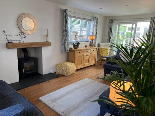 a living room with a couch and a fireplace at Exmouth Luxury Coastal Boutique Town House in Exmouth