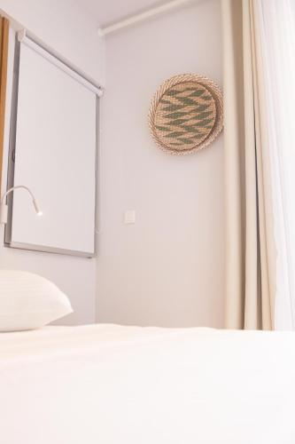 a bedroom with a window and a bed with a curtain at Dimani Suites in Gythio