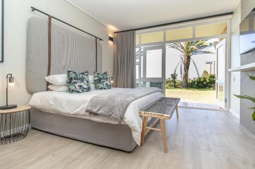 a bedroom with a large bed and a large window at 36 At Brookes in Summerstrand