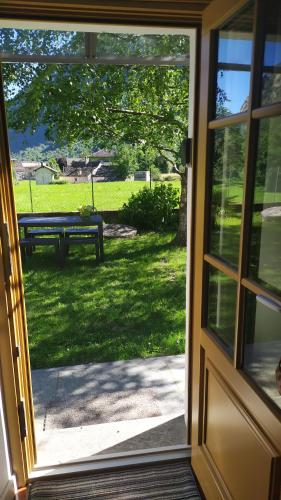 an open door with a view of a picnic table at STONE in Crodo