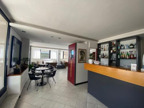 a kitchen with a bar and a dining room at Hotel Sedonia in Cervia