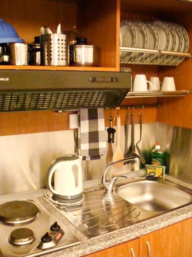 a kitchen counter with a sink and a stove at PANSION KONSTANTINOS in Skiathos