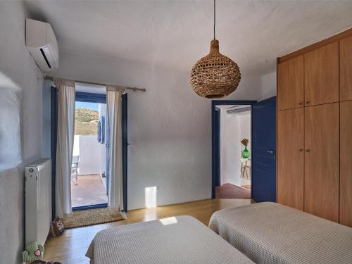 a room with a bed and a mirror on the wall at Leticia Villa with pool with amazing sea views, Paros in Márpissa