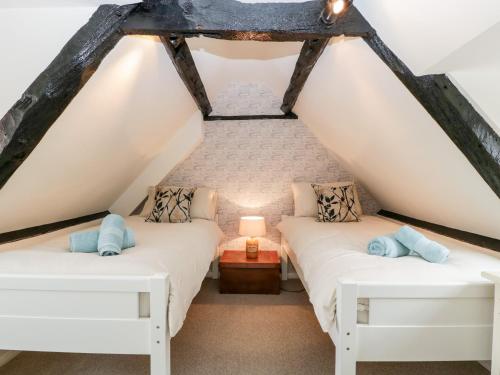 two beds in the attic bedroom of a house at 7 Church Lane in Lymington