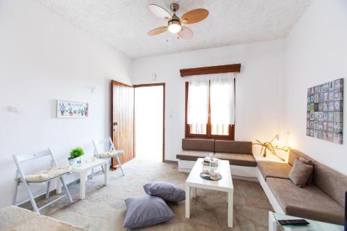 a living room with a couch and a table at F & B Summer Collection - Holiday Flats in Sozopoli