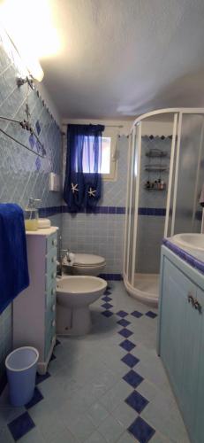 a bathroom with a sink toilet and a shower at Sardinia82 Sunsetplace in Palau