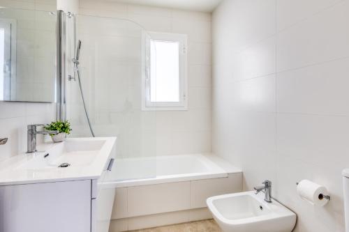 a white bathroom with a sink and a bath tub at Hanami Puerto Blanco (PB-23-3IZQ) in Estepona