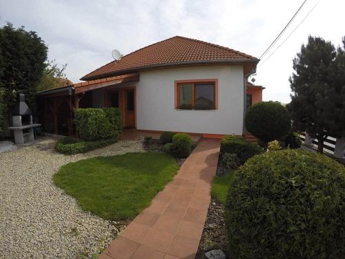 a small house with a walkway in front of it at Vila Daja in Podhájska