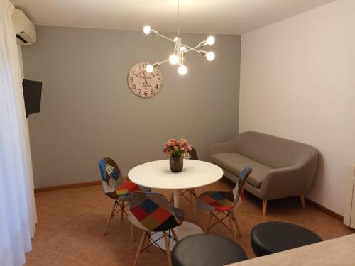 a living room with a table and chairs and a couch at Apartments Leo in Rovinj