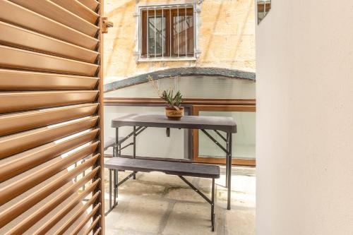 a table in front of a building with a window at ConVivo Apartment in Lecce