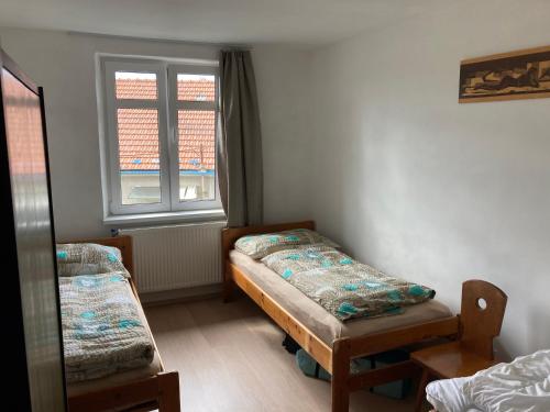 a room with two beds and a window at Vila Galant in Konice