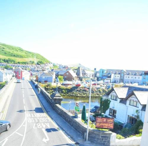 a view of a town with a river and houses at Bridge View Victorian Townhouse Central Aberystwyth Sleeps 6 in Aberystwyth