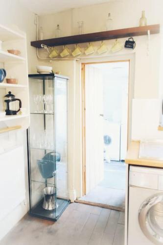 a kitchen with a glass case in a room at Bridge View Victorian Townhouse Central Aberystwyth Sleeps 6 in Aberystwyth