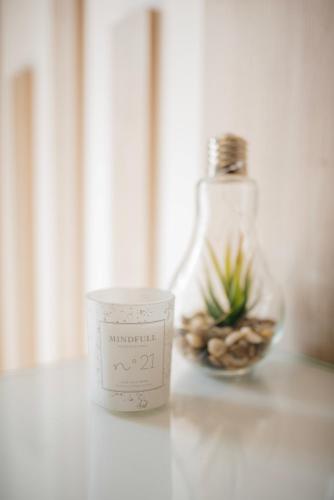 a candle sitting on a table next to a bottle at Hotel - Villa Lejla in Mostar