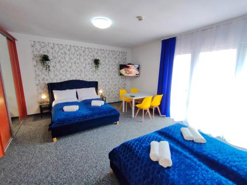 A bed or beds in a room at Great Polonia Sand Beach Mielno