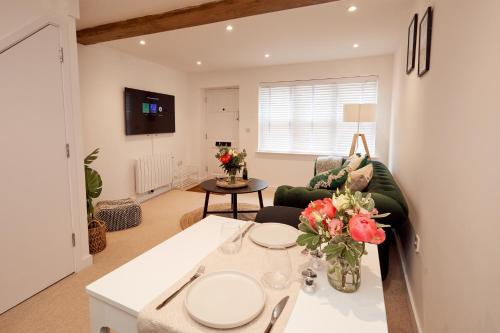 a living room with a couch and a table at Norton Studio in Arundel