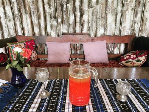 a drink in a glass sitting on a table at Saschiz 130/Lodging and Glamping in Saschiz