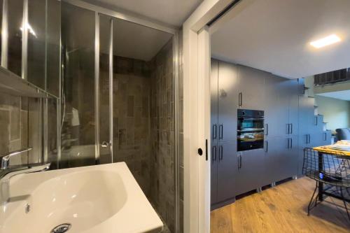 a bathroom with a tub and a glass shower at Green Göcek Tiny Houses in Gökçeovacık