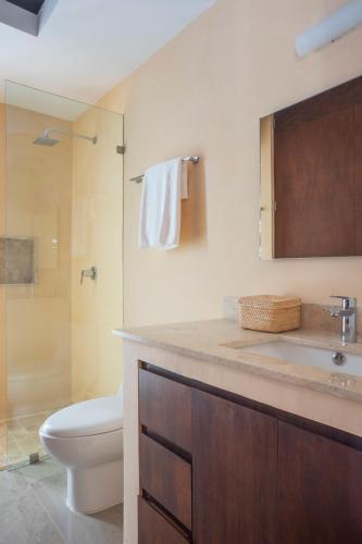 a bathroom with a toilet and a sink and a shower at New Tulum Luxury 2BRBath with Private Pool Heart of La Veleta in Tulum