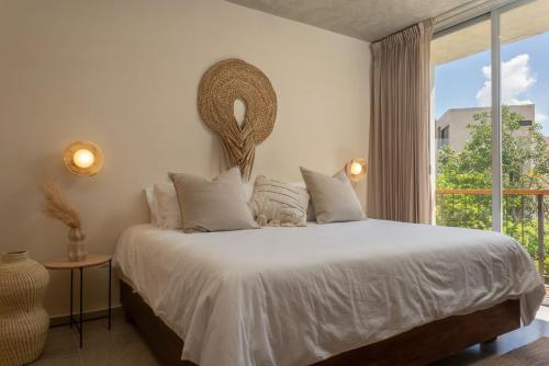 a bedroom with a bed with a large window at New Tulum Luxury 2BRBath with Private Pool Heart of La Veleta in Tulum