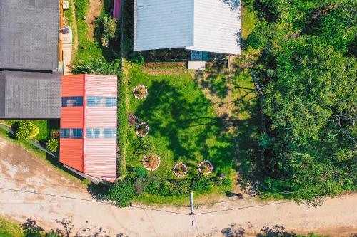 an overhead view of a yard with a red building at La Casa en el Aire Mindo, 4 Dormitorios in Mindo