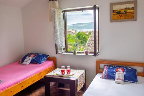 a room with two beds and a window at Private rooms - Tivat in Tivat