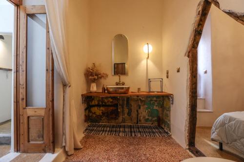 a bathroom with a sink and a mirror at SIKATE Hospitality in Mikonos