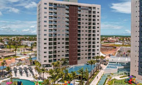 an aerial view of a tall building with a pool at Salinas Premium Resort in Salinópolis