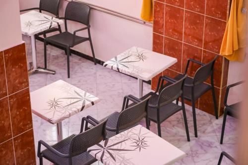 a row of tables and chairs in a restaurant at Hotel EL MARSA LA PLAYA in Laayoune