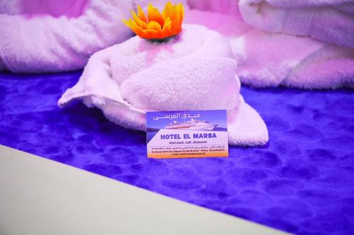 a room with a pile of towels and a sign at Hotel EL MARSA LA PLAYA in Laayoune
