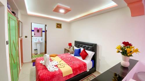 a bedroom with a bed and a vase of flowers at Hotel EL MARSA LA PLAYA in Laayoune