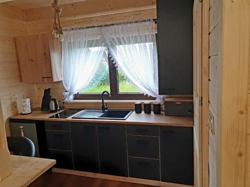 a kitchen with a sink and a window at Trzy Szczyty-Turbacz in Grywałd