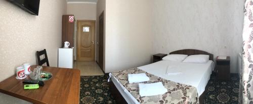 a small room with a bed and a table at Hotel LaMa 2 in Kyiv