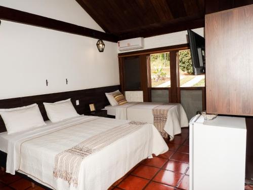 En eller flere senge i et værelse på Pousada Recanto do Turvo