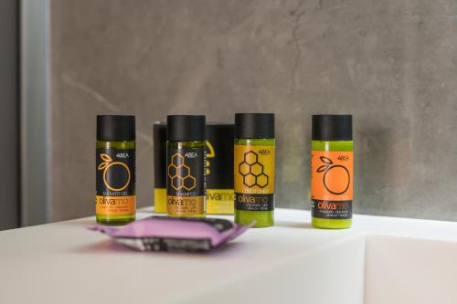 a group of four bottles of essential oils on a counter at Alkionides Seaside Hotel in Plataniás
