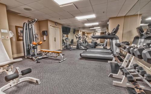 a gym with treadmills and machines in a room at Hôtel Palace Royal Centre-Ville Québec par JARO in Quebec City