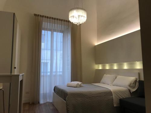 Ένα ή περισσότερα κρεβάτια σε δωμάτιο στο Motta Palace Apartments & Rooms