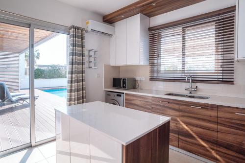 een keuken met een wastafel en een aanrecht bij Villa Aquamarine in Paphos City