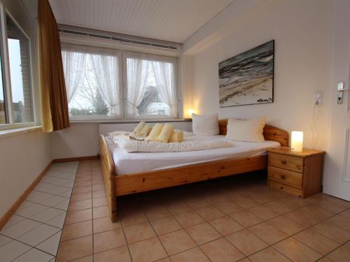 a bedroom with a bed with white sheets and pillows at Ferienwohnung in Westerland auf Sylt in Westerland (Sylt)