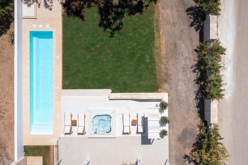 an overhead view of a house with a swimming pool at Sea View White Villa in Stavros