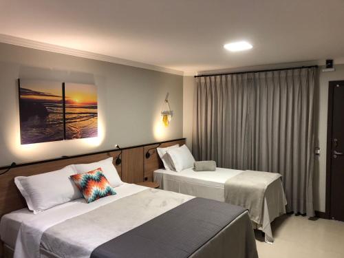 Cama o camas de una habitación en B14 Suítes