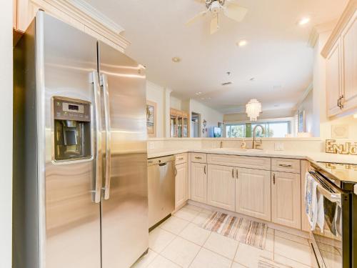 a large kitchen with a stainless steel refrigerator at South Beach Club 205, 3 Bedrooms, Sleeps 6, Ocean View, 2nd Floor, Elevator in Flagler Beach