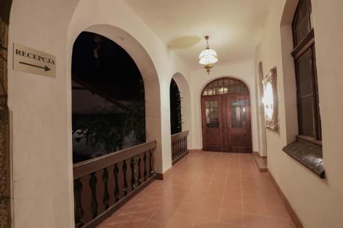 a hallway of a house with a wooden door at Wrzos & Belvedere in Kudowa-Zdrój