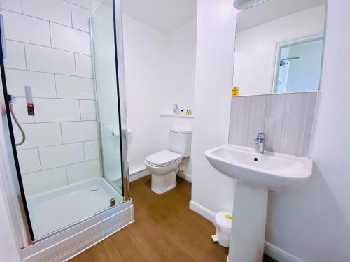 a bathroom with a sink and a toilet and a shower at The Esplanade Hotel by Compass Hospitality in Paignton