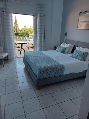 a bedroom with a bed and a table and a patio at Maria Studios in Paleokastritsa